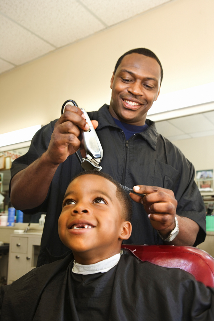 Boy getting haircut at barbershop